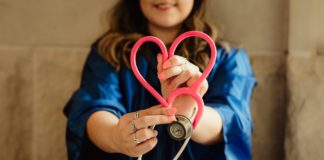 A nurse holds out a stethascope