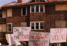 a group of protestors march with handmade signs