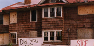 a group of protestors march with handmade signs