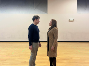 The male and female leads of the opera gaze into each other's eyes during rehearsal