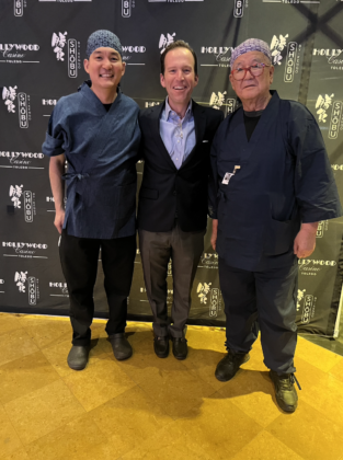 Three men pose together