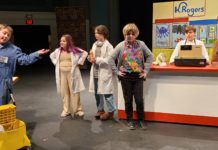 child actors onstage in front of scenery evoking a grocery store