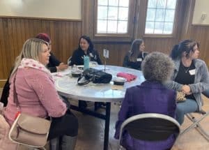 a table of women converse
