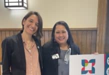 HerHub coordinator and Women of Toledo managing director stand at an event