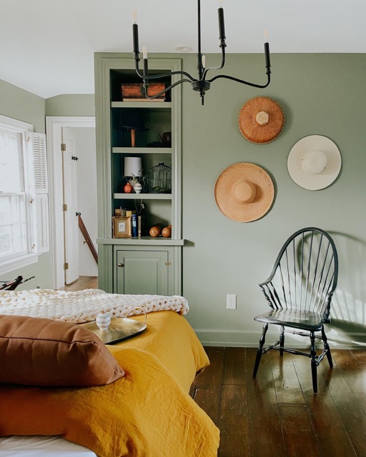 bedroom suite containing windows, bed, chair, and bookshelves