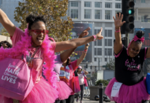 Two women in pink jump around