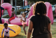 A little girl plays with inflatables