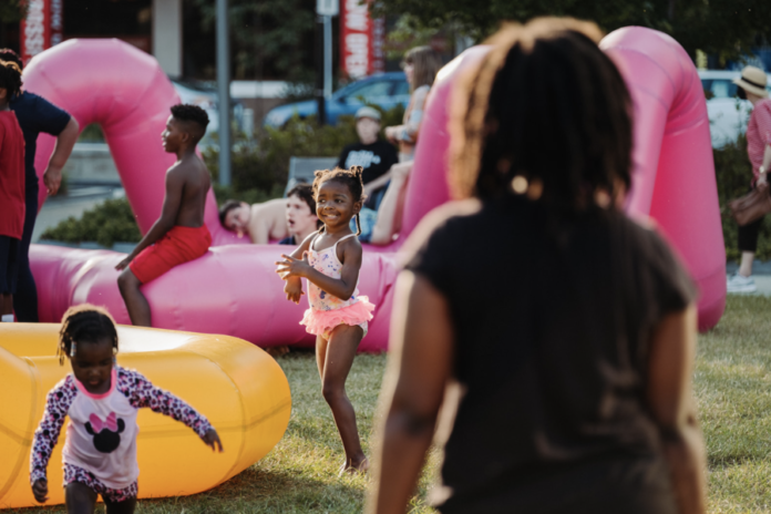 A little girl plays with inflatables