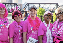 Five women wearing pink