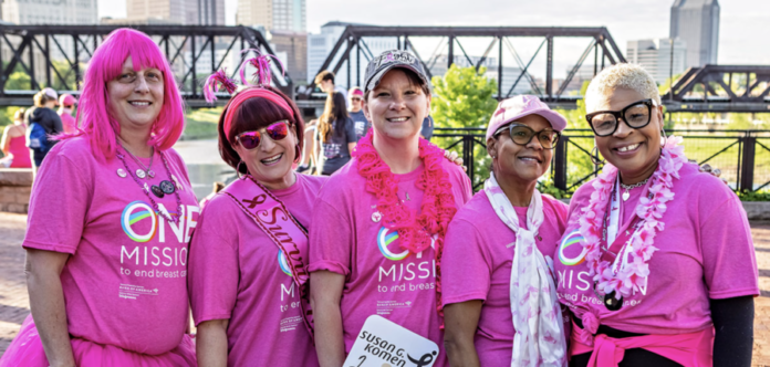 Five women wearing pink