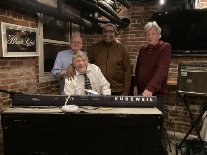 Bob Manley, Clark Brooks, John Johnson (left to right, standing), and Tim Tiderman (sitting) of Organic Ingredients