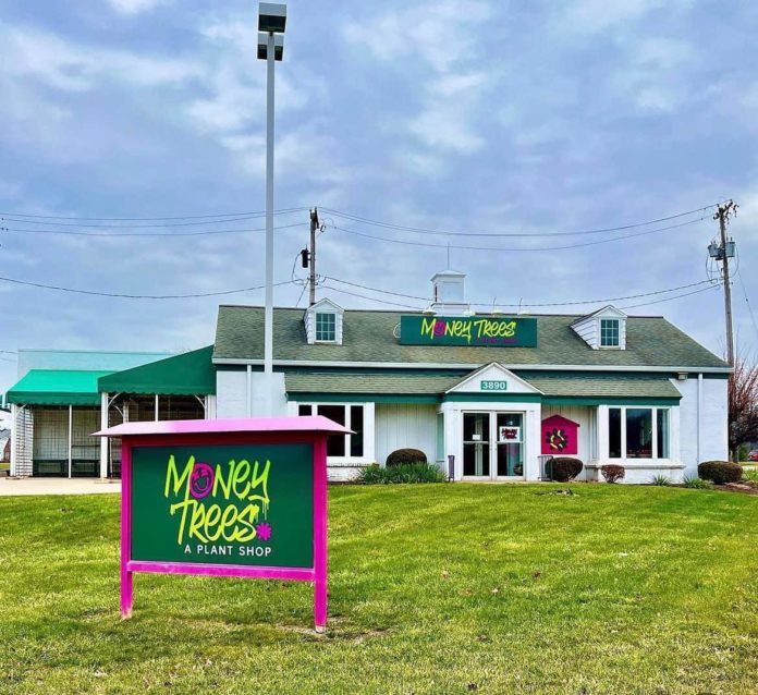 Outside of the new plant store's front with their sign.