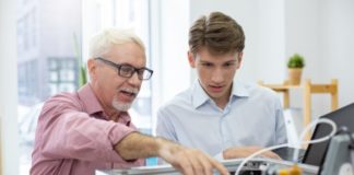 Student being shown what to do by a teacher/parent.