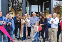 Dani Fuller cutting the ribbon for the grand re-opening of The Fuller Art House.