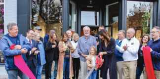 Dani Fuller cutting the ribbon for the grand re-opening of The Fuller Art House.