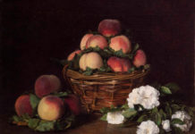 A basket of apples with some white flowers