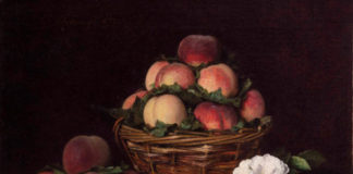 A basket of apples with some white flowers