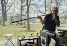 an artist works on a glass blown piece