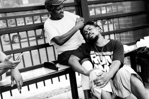 Two men sitting at a bench.