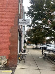 The view of Maddie & Bella Coffee Roasters from the outside with their welcome sign.
