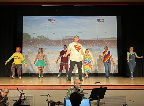 Trent (Brock Burkett) leading the ensemble in "The Acceptance Song."